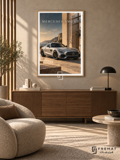 Mercedes-AMG GT Coastal (car13), Wooden Texture frame with white printed border in a styled interior. A silver Mercedes-AMG GT stands beside sunlit stone architecture overlooking a rocky coast. Warm beige stone and muted blue sky surround the car beneath MERCEDES-AMG GT lettering.