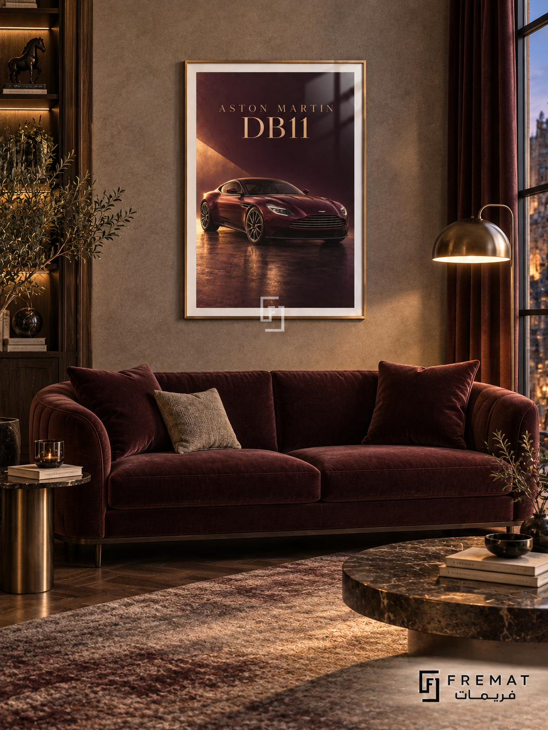 Aston Martin DB11 (car19), Gold frame with white printed border in a styled interior. A burgundy Aston Martin DB11 sits on a glossy dark floor under a warm diagonal shaft of light. Gold-toned ASTON MARTIN DB11 lettering completes the wine-red composition.