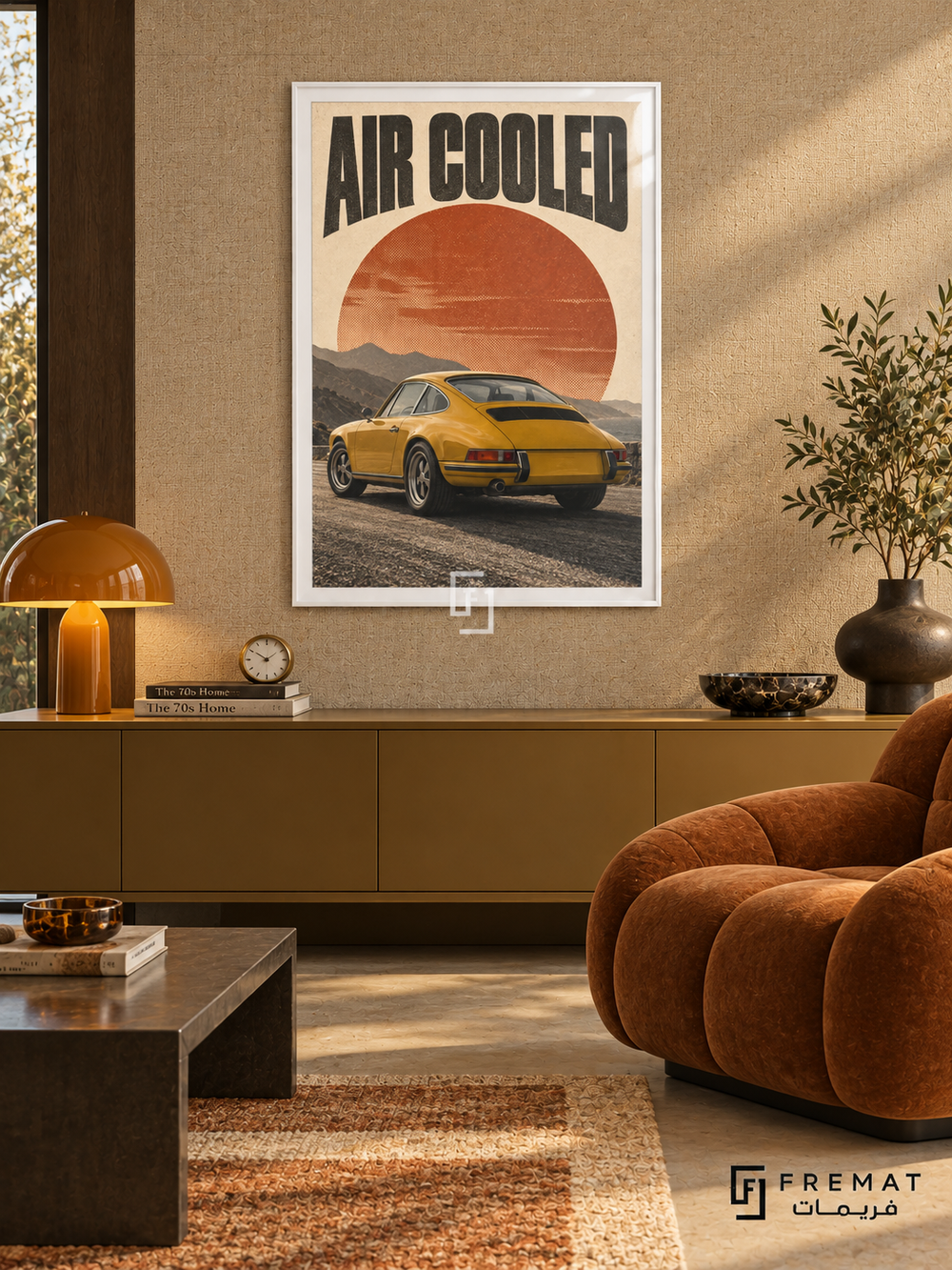 Air Cooled (car26), White frame with white printed border in a styled interior. A mustard-yellow classic coupe is shown from the rear against layered mountains and a large rust-orange sun. Curved black lettering reads AIR COOLED on warm cream paper.