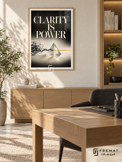 Clarity Is Power (com05), Wooden Texture frame with white printed border in a styled interior. A tangled black line enters a transparent triangular prism and emerges as a straight gold line. Large cream lettering reads “CLARITY IS POWER” above the conceptual black-and-ivory composition.