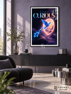 Stay Curious (com22), Black frame with white printed border in a styled interior. A blue origami bird flies toward a glowing peach portal above purple clouds, followed by luminous cursor-like shapes. Gradient blue and coral lettering reads “STAY CURIOUS”.