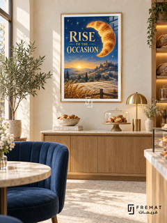 Rise to the Occasion (com28), Gold frame with white printed border in a styled interior. A golden croissant floats like a crescent moon above wheat fields, hills and a distant town at sunrise. Gold lettering reads “RISE TO THE OCCASION” against a starry blue sky.