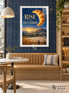 Rise to the Occasion (com28), White frame with white printed border in a styled interior. A golden croissant floats like a crescent moon above wheat fields, hills and a distant town at sunrise. Gold lettering reads “RISE TO THE OCCASION” against a starry blue sky.