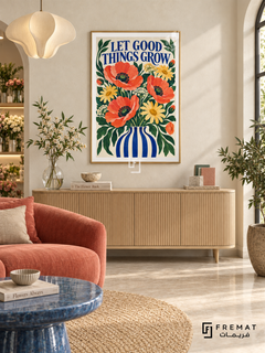 Let Good Things Grow (com29), Gold frame with white printed border in a styled interior. Red poppies, yellow daisies and white blossoms fill a blue-and-white striped vase. Dark green foliage surrounds blue “LET GOOD THINGS GROW” lettering in a lively painted floral illustration.