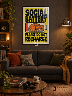 Social Battery (fun02) — Black frame, white paper border and FREMAT branding in a styled interior. A grumpy orange cat curls inside a low-battery symbol. Bold black lettering on bright yellow reads “SOCIAL BATTERY — PLEASE DO NOT RECHARGE,” in a textured cartoon poster.