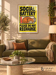 Social Battery (fun02) — Gold frame, white paper border and FREMAT branding in a styled interior. A grumpy orange cat curls inside a low-battery symbol. Bold black lettering on bright yellow reads “SOCIAL BATTERY — PLEASE DO NOT RECHARGE,” in a textured cartoon poster.