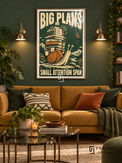 Big Plans Snail (fun05) — Gold frame, white paper border and FREMAT branding in a styled interior. A snail carries a towering stack of books while a butterfly hovers nearby. Cream lettering reads “BIG PLANS — SMALL ATTENTION SPAN” over forest green and orange linocut-style illustration.