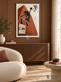 Above The Noise: A basketball player rises toward a hoop against terracotta architecture and a cream sky, with bold editorial lettering. Gold frame with a white printed border, displayed in a styled room.