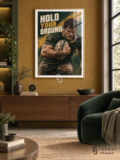 Hold Your Ground: A rugby player grips an oval ball in a forest-green and ochre composition with rugged painted texture. Gold frame with a white printed border, displayed in a styled room.