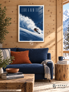 Leave A New Trace: A snowboarder in an orange jacket carves through powder on a deep cobalt slope beneath tall, light lettering. Wooden Texture frame with a white printed border, displayed in a styled room.