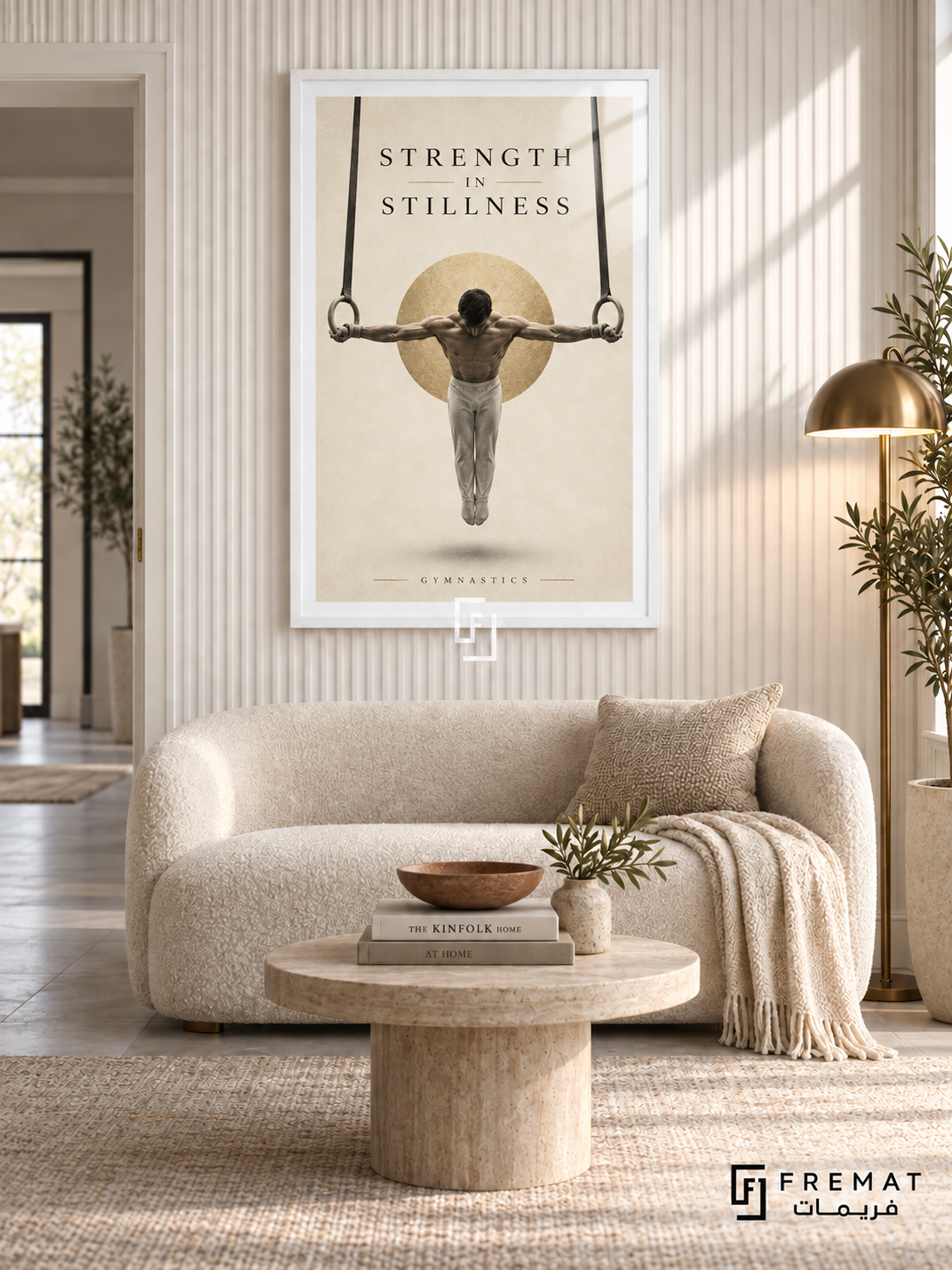 Strength In Stillness: A gymnast holds a rings pose against warm ivory space, a soft charcoal shadow and a subtle gold disc. White frame with a white printed border, displayed in a styled room.