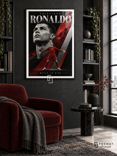 Cristiano Ronaldo: Cristiano Ronaldo appears in a monochrome portrait above a smaller red number-7 figure with outstretched arms, amid crimson and silver diagonals. Black frame with a white printed border, displayed in a styled room.