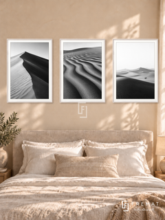 Desert Lines — set of three complementary black and white artworks in White frames, shown at 50×70 cm each.
