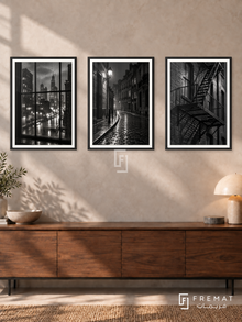 Urban Rain — set of three complementary black and white artworks in Black frames, shown at 50×70 cm each.