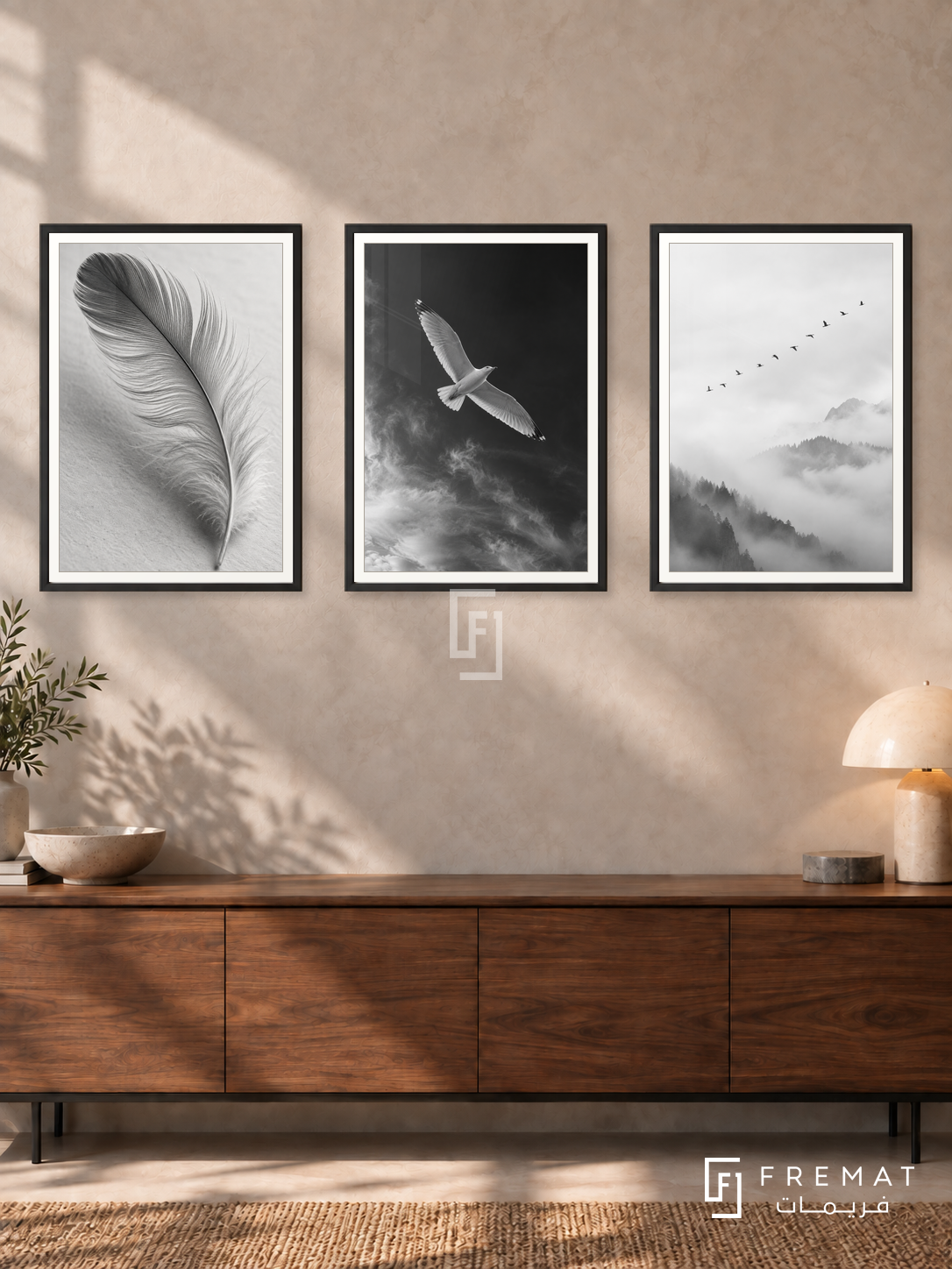 Feather And Flight — set of three complementary black and white artworks in Black frames, shown at 50×70 cm each.