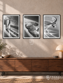 Glass And Water — set of three complementary black and white artworks in Black frames, shown at 50×70 cm each.