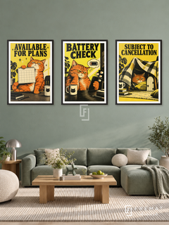 Battery — set of three complementary funny artworks in Black frames, shown at 50×70 cm each.