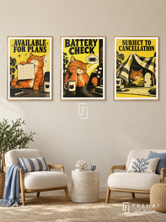 Battery — set of three complementary funny artworks in Gold frames, shown at 50×70 cm each.