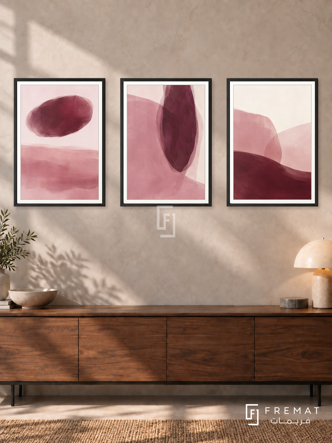 Blush And Burgundy — set of three complementary modern abstract artworks in Black frames, shown at 50×70 cm each.