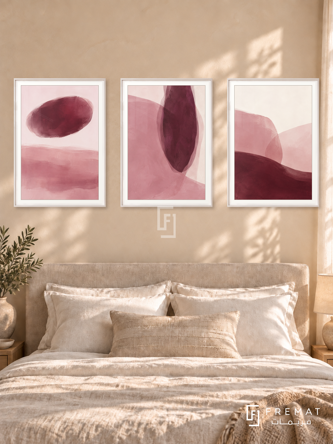 Blush And Burgundy — set of three complementary modern abstract artworks in White frames, shown at 50×70 cm each.