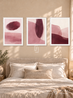 Blush And Burgundy — set of three complementary modern abstract artworks in White frames, shown at 50×70 cm each.